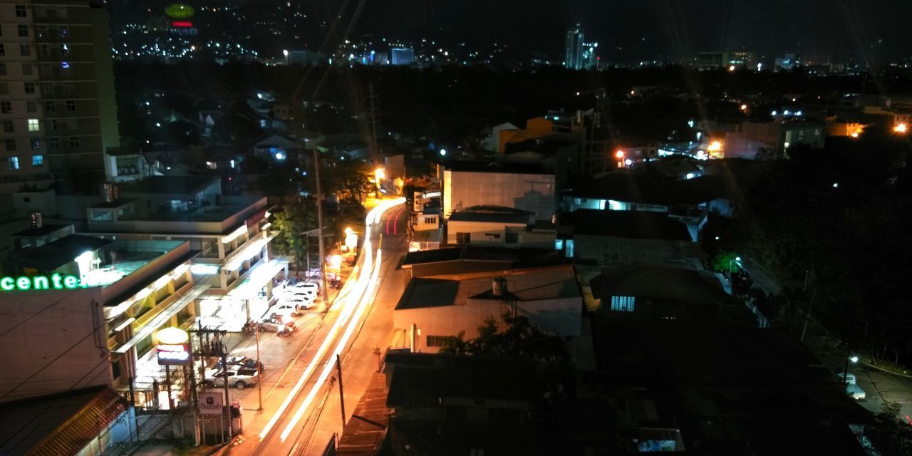 HIGH ANGLE VIEW OF ILLUMINATED BUILDINGS AT NIGHT