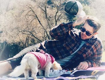 Full length of young man with dog outdoors