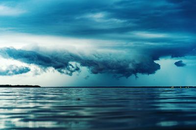 Scenic view of sea against storm clouds