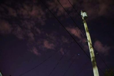 Low angle view of power lines against sky