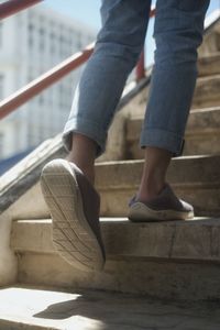 Low section of man standing on staircase