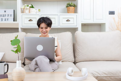 Woman using laptop at home