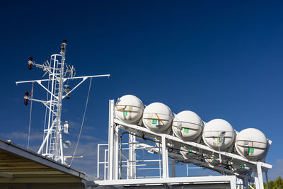 Low angle view of cityscape against clear blue sky