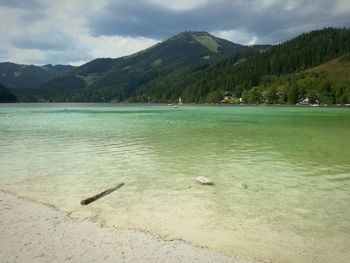 Scenic view of lake against cloudy sky