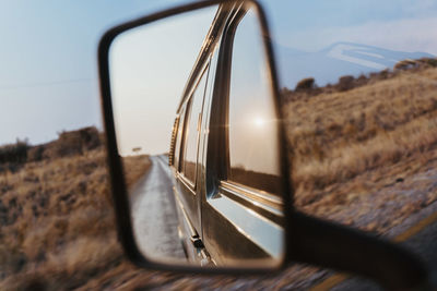 Close-up of side-view mirror of car