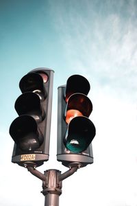 Low angle view of road signal against sky