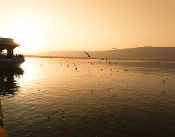 Scenic view of sea against clear sky during sunset