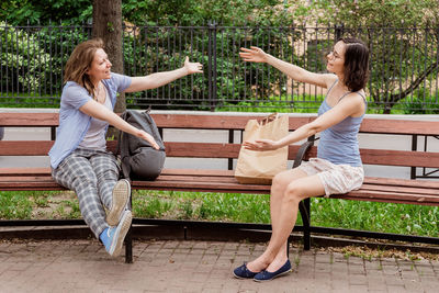 Friends hug each other in the air. greeting girls with social distancing