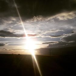 Scenic view of landscape against cloudy sky