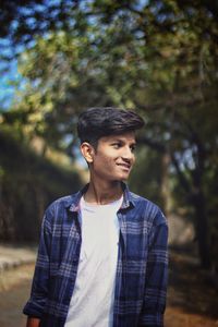 Smiling young man looking away outdoors