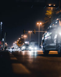 Illuminated city street at night