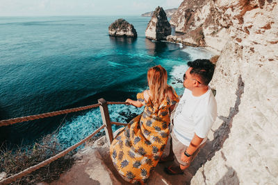 High angle view of couple looking at sea