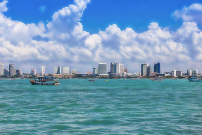 Scenic view of sea and buildings against sky