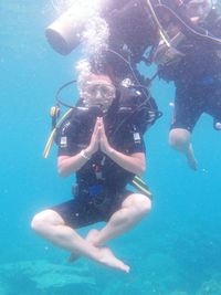 Young woman scuba diving in sea