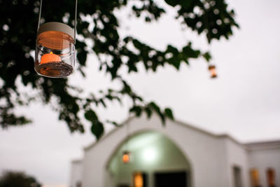 Low angle view of decoration hanging on tree against sky