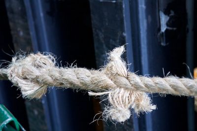 Close-up of rope tied up on metal