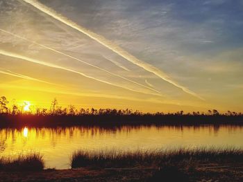 Scenic view of lake against sky during sunset