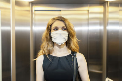 Portrait of beautiful woman standing in corridor