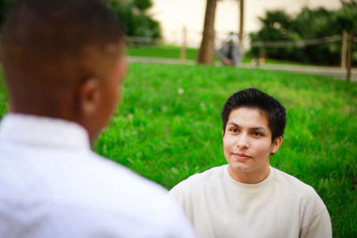 Portrait of young man on grassy field