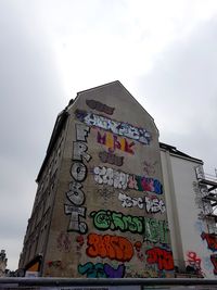 Low angle view of information sign against sky