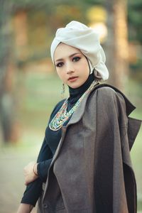 Portrait of young woman standing outdoors