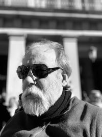 Bearded senior man wearing sunglasses in city