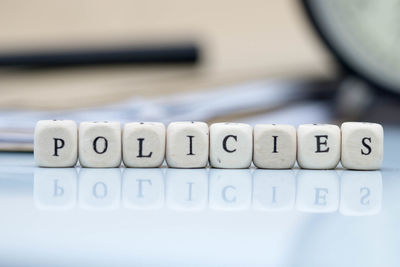 Close-up of policies text made with toy blocks on white background