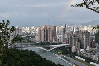 Aerial view of city and buildings against sky