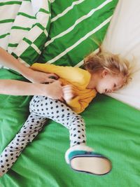 Close-up of girl playing on bed