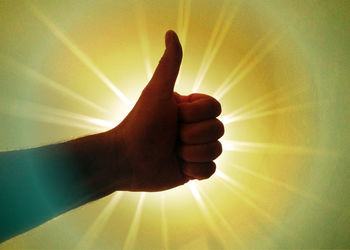 Cropped image of hand holding sun