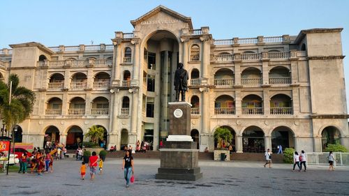 Tourists at entrance of historic building