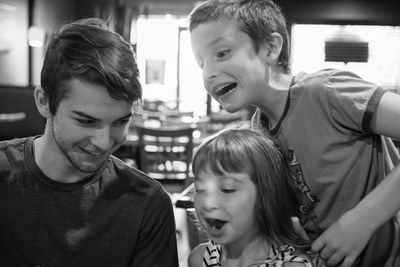 Cheerful siblings at restaurant