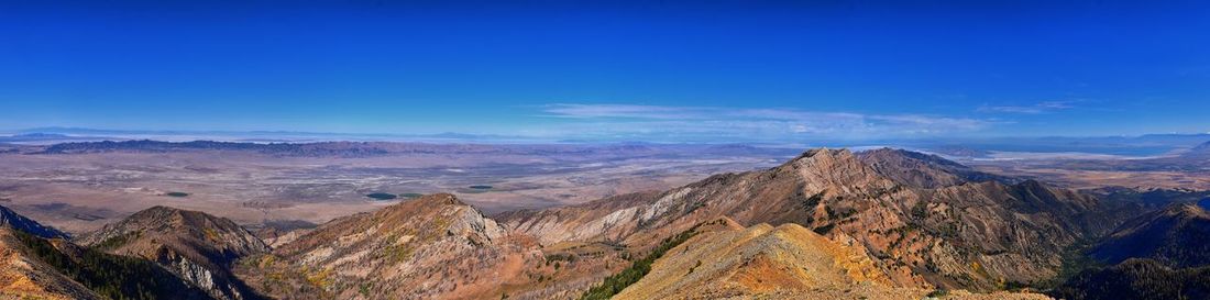 Scenic view of mountains against blue sky