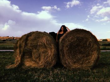 Hay bales on field against sky