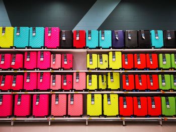 Close-up of multi colored suitcase for sale