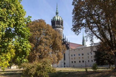 Panoramic view of trees and buildings against sky