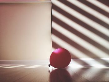 Close-up of magenta balloon on table at home