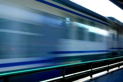 Blurred motion of train at railroad station