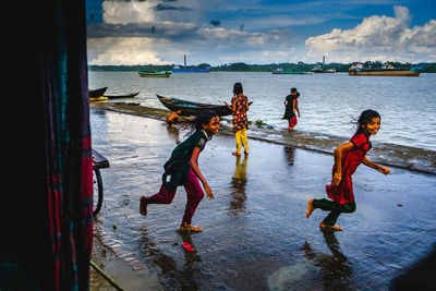 People on beach against sky