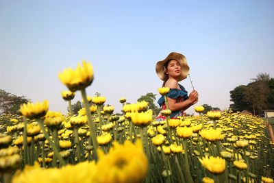 Full length of sunflower on field against sky