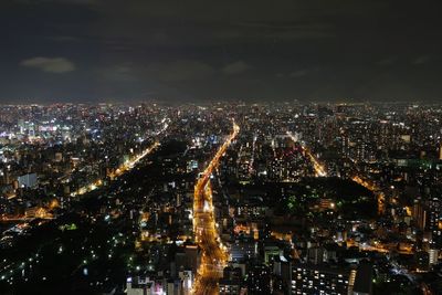 High angle view of illuminated city buildings at night