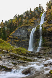 Scenic view of waterfall against sky