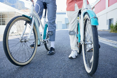 Low section of man riding bicycle on street