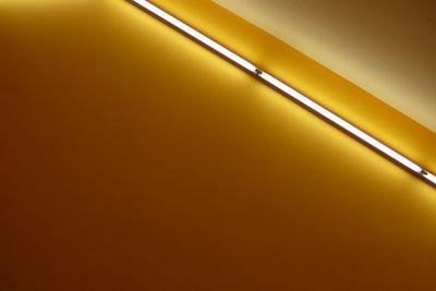 Low angle view of tube light on the wall