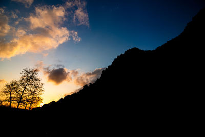 Low angle view of silhouette mountain against sky during sunset
