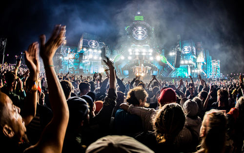 Rear view of people enjoying at music concert