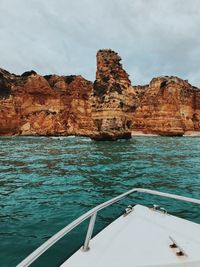 Scenic view of rock formation in sea against sky