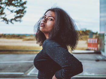 Portrait of a young woman looking away