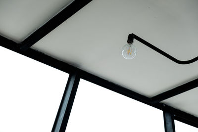 Low angle view of light bulb hanging from ceiling