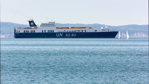 Ship sailing on sea against sky